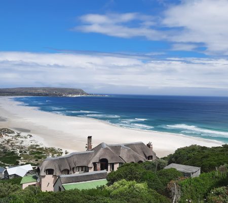 a house on a hill overlooking the ocean