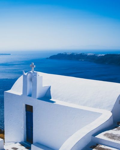 white concrete building near body of water during daytime